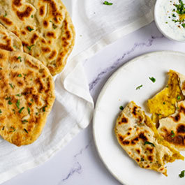 Spicy stuffed naan with potatoes and mint dip