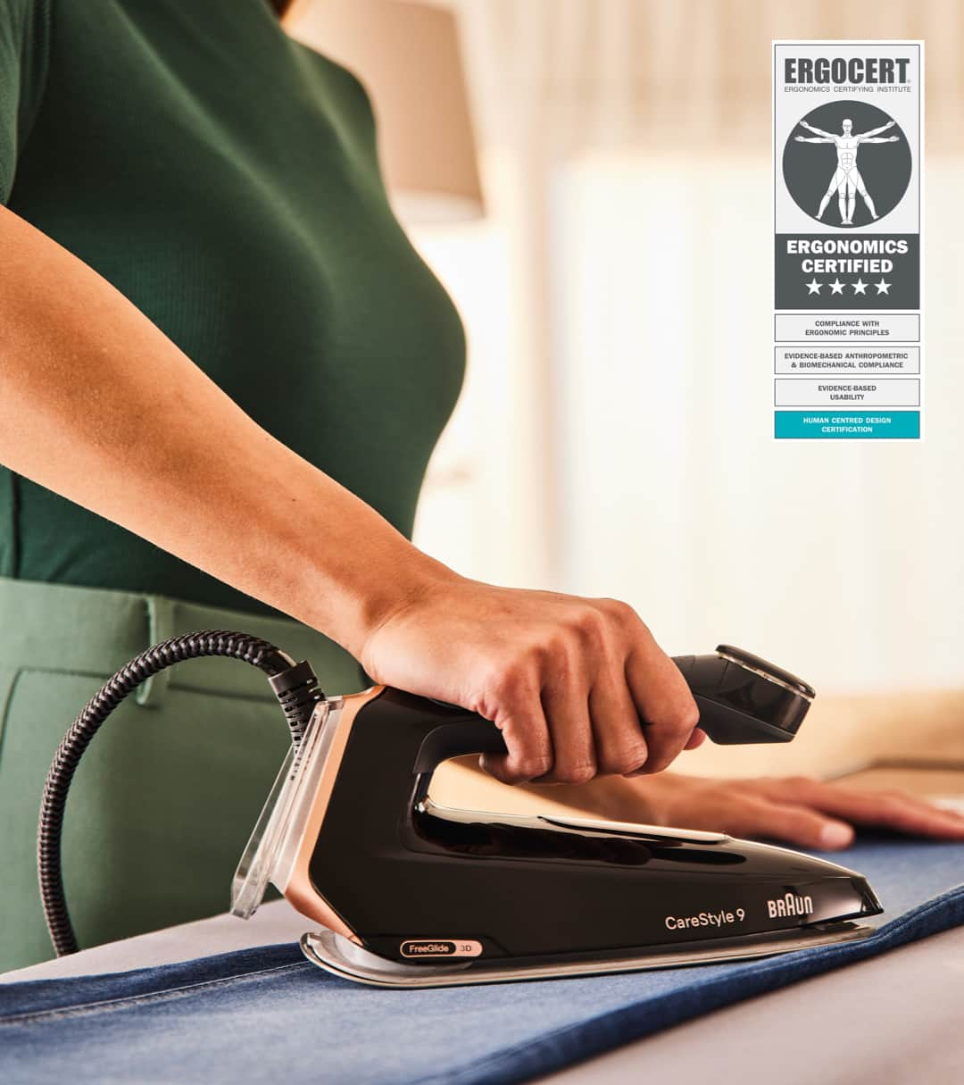 Woman irons jeans in ergonomic position using Braun's CareStyle 9 steam generator iron