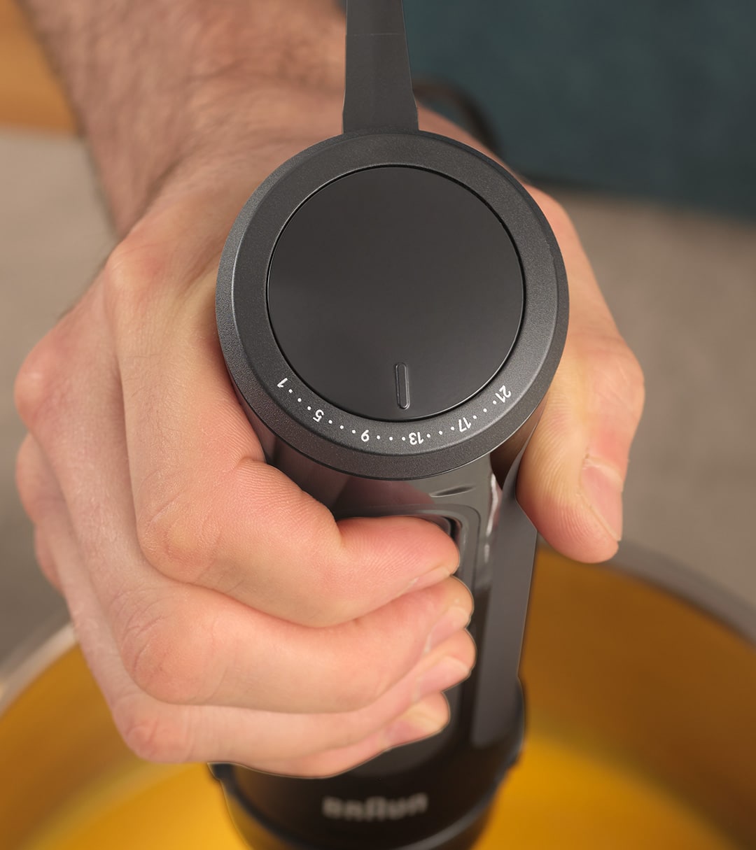 A person confidently holds a MultiQuick 5 Hand blender in their hand, ready to prepare a delicious smoothie or meal.