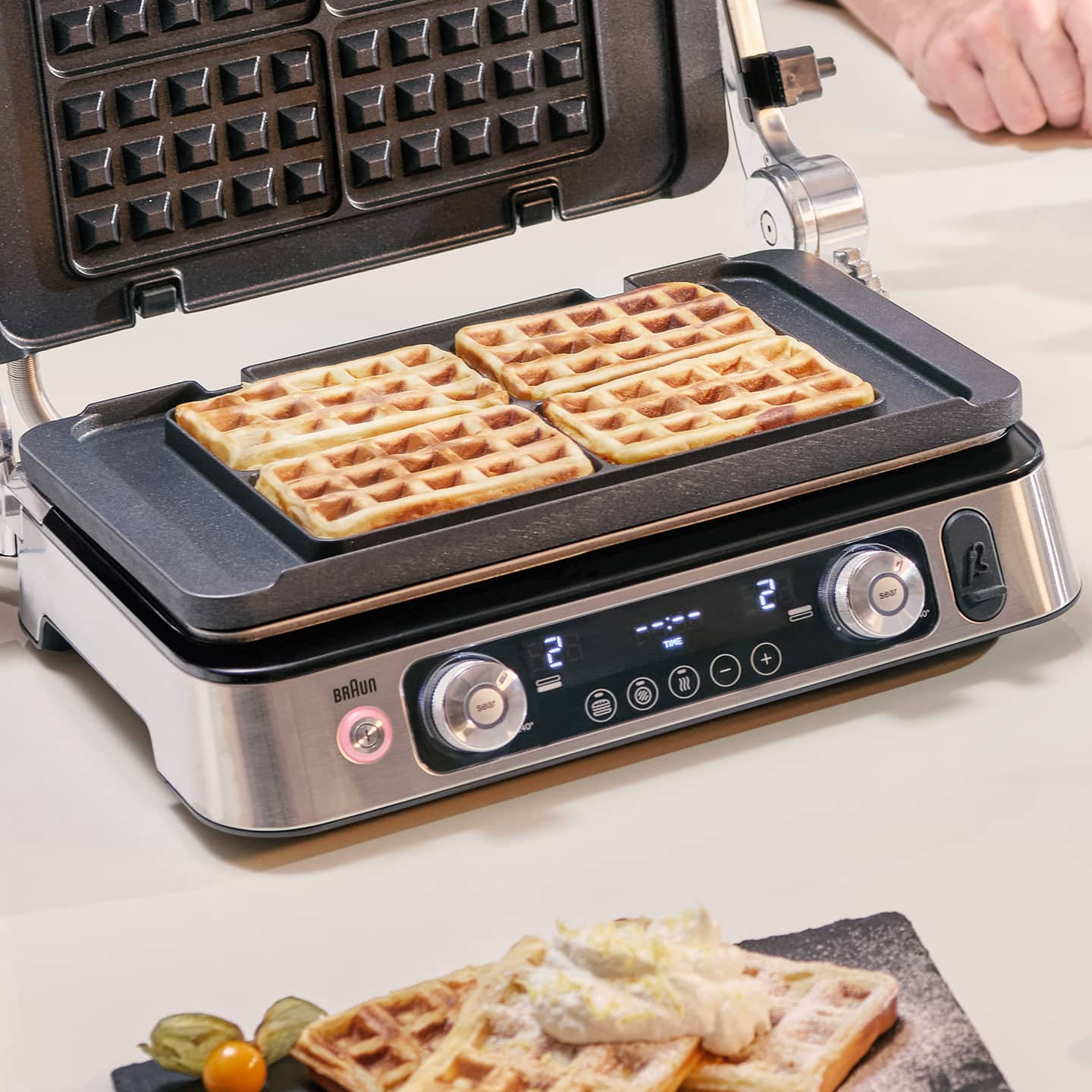 Braun MultiGrill 9 with two golden-brown waffles resting on top